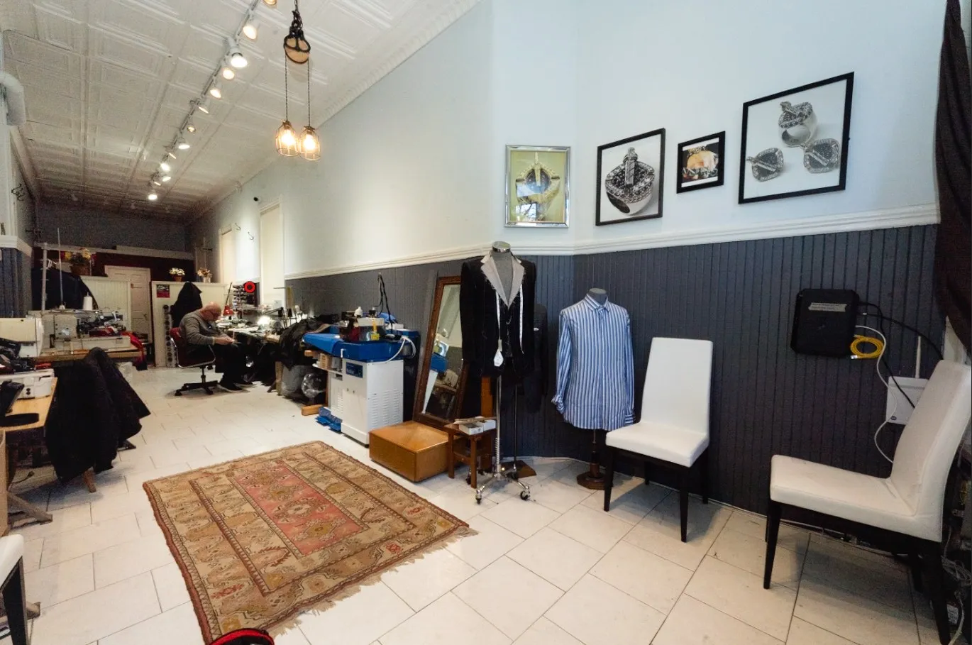 Inside Gregory's Fine Tailoring in Waltham, MA: sewing stations, a tailored suit and dress shirt on display